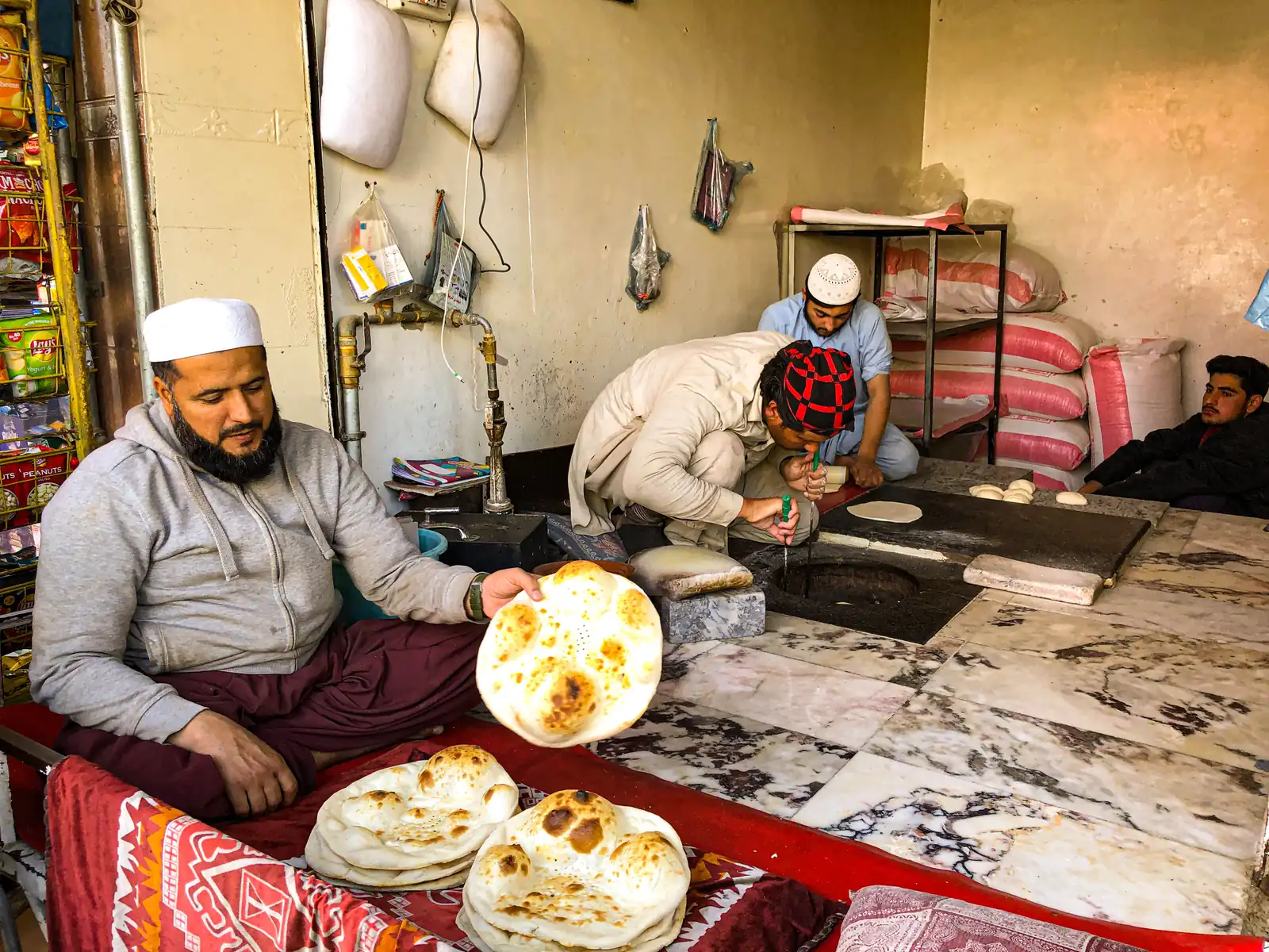 Bakers making fresh naan at a bakery in Swat, Pakistan