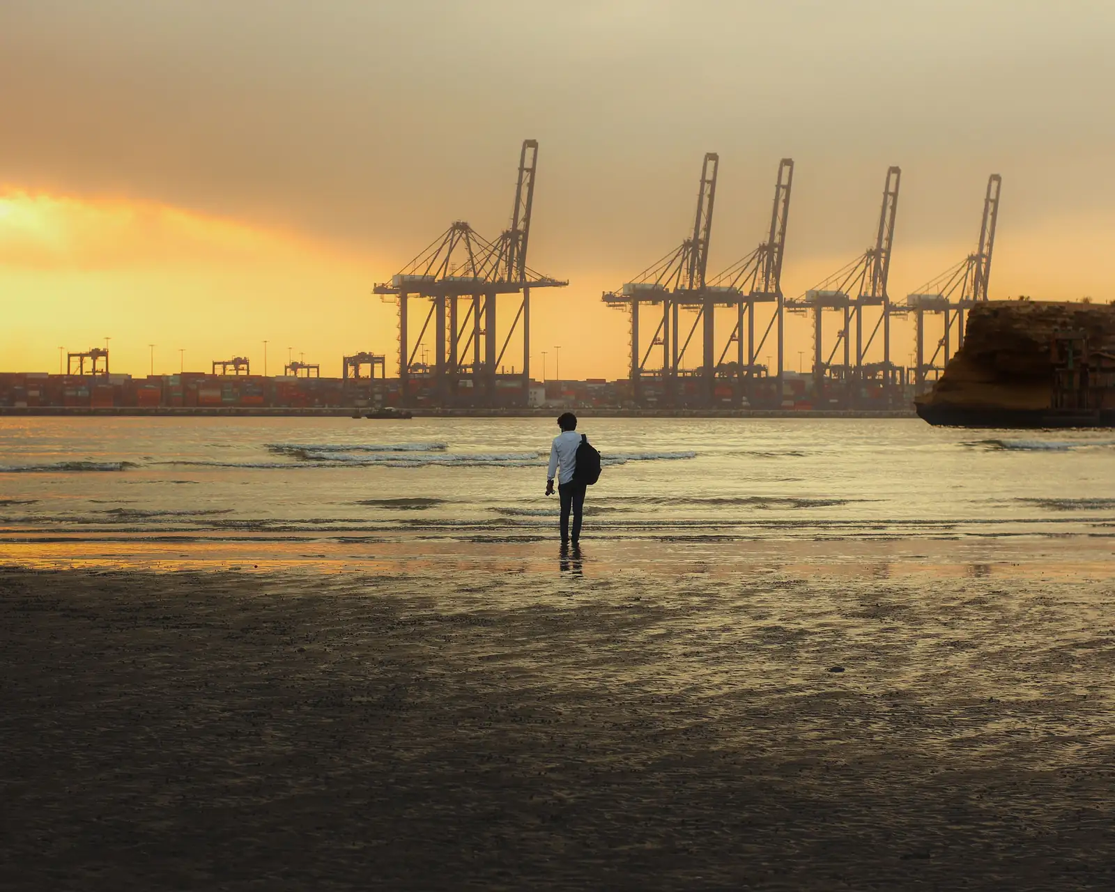Container cranes at Karachi Port, Pakistan, at sunset